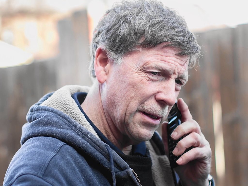 Picture of Pastor Jon talking on a cellphone